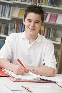 Student writing and studying
