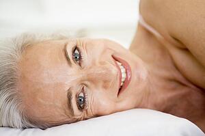 Woman lying in bed smiling