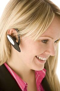 Businesswoman Talking On Hands Free Phone
