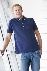 Man standing in corridor smiling