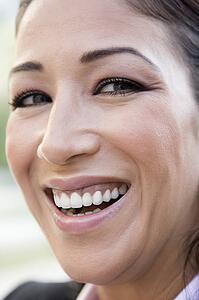 Woman's smiling face outdoors (selective focus)