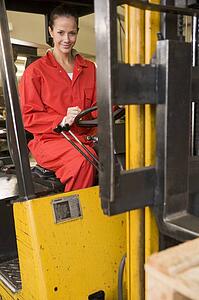 Warehouse worker in forklift