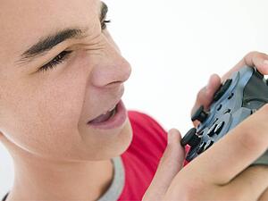 Teenage boy using videogame controller