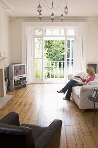 Woman in living room watching television