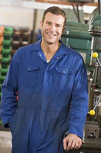 Machinist working on machine