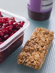 Pomegranate Seeds With A Cereal Bar And Berry Smoothie