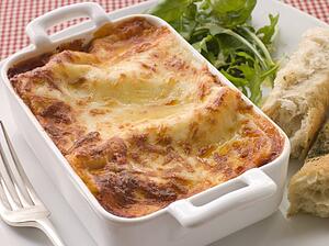Dish of Lasgane with Salad Leaves and Italian Bread