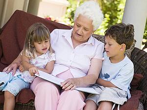 Grandmother reading to grandchildren.
