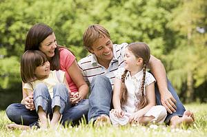 Family outdoors smiling