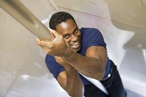Fireman sliding down fire pole smiling (selective focus)