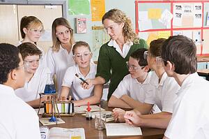 Students receiving chemistry lesson in classroom