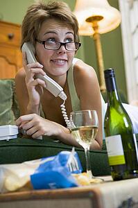 Young woman at home talking on telephone