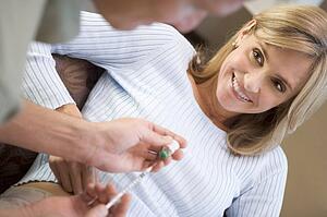 Man helping woman inject drugs to prepare for IVF treatment (selective focus)