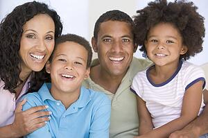 Family in living room smiling
