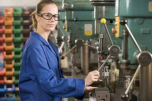 Machinist working on machine