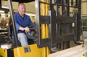 Warehouse worker in forklift