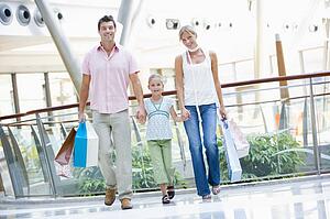 Mother and father with young daughter at a shopping mall
