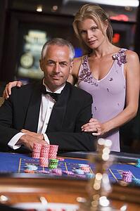 Couple in casino playing roulette and smiling (selective focus)