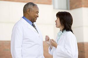 Two Doctors Standing Outside A Hospital