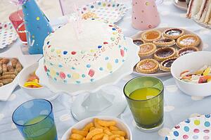 Birthday party table setting with food