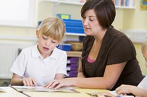 Student in class with teacher reading