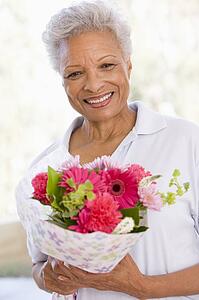 Woman holding flowers and smiling