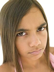 Young girl frowning