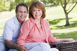 Couple at a picnic holding hands and smiling