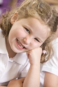 Student in class smiling (selective focus)