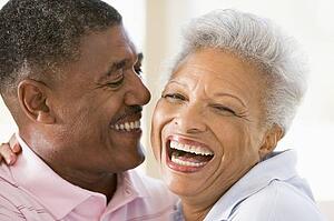 Couple relaxing indoors laughing