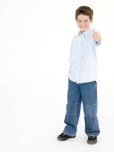 Young boy giving thumbs up smiling