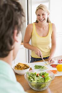 Woman Talking To Husband While Preparing meal, mealtime