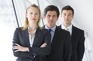 Three businesspeople standing in corridor