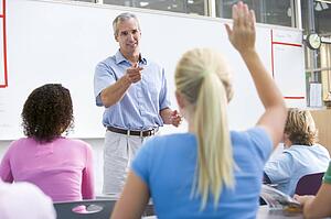 Students answering questions in math class with teacher