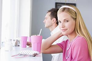 Young couple having a cold drink in a cafeteria