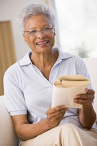 Woman relaxing with a book and smiling