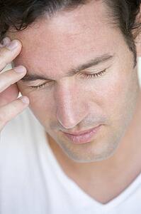Head shot of man scowling