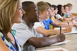 Students in class paying attention and taking notes (selective focus)