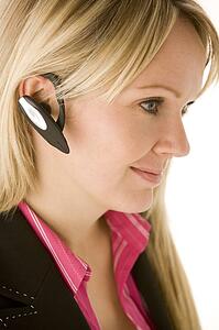 Businesswoman Talking On Hands Free Phone 
