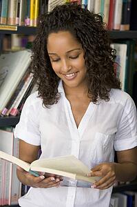 Woman in library reading book