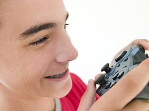 Teenage boy using videogame controller