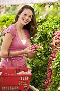 Woman shopping for beets at a grocery store
