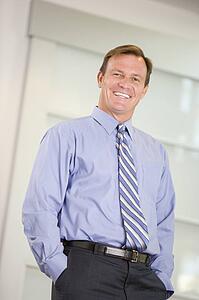 Businessman standing indoors smiling
