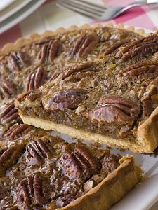 Pecan Pie With A Slice Being Cut