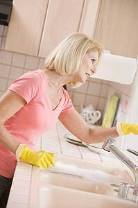 Woman Cleaning Kitchen Counter