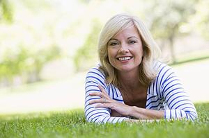Woman relaxing outdoors smiling