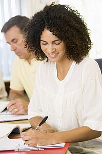 Adult students studying at table (selective focus)