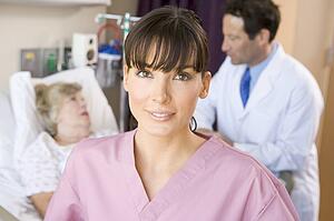 Nurse Standing In Hospital Room, Doctor Talking With Patient