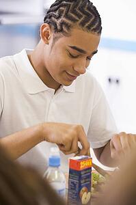 Student having lunch in dining hall
