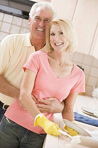 Husband And Wife Cleaning Dishes
